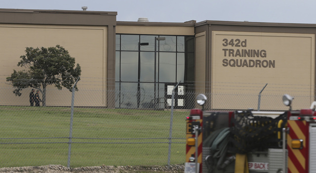 Two Bexar County Sheriff's Deputies, left, stand outside a building near the scene of a shooting at Joint Base San Antonio-Lackland, Friday, April 8, 2016, in Texas. (John Davenport/The San Antoni ...