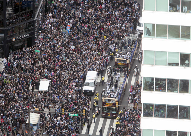 Members of the Villanova basketball team ride on buses during a parade celebrating their NCAA college basketball championship, Friday, April 8, 2016 in Philadelphia. Villanova defeated North Carol ...