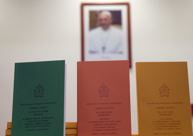 Copies of the post-synodal apostolic exhortation ' Amoris Laetitia ' (The Joy of Love) document are on display prior to the start of a press conference, at the Vatican, Friday, April 8, 2016.  (An ...
