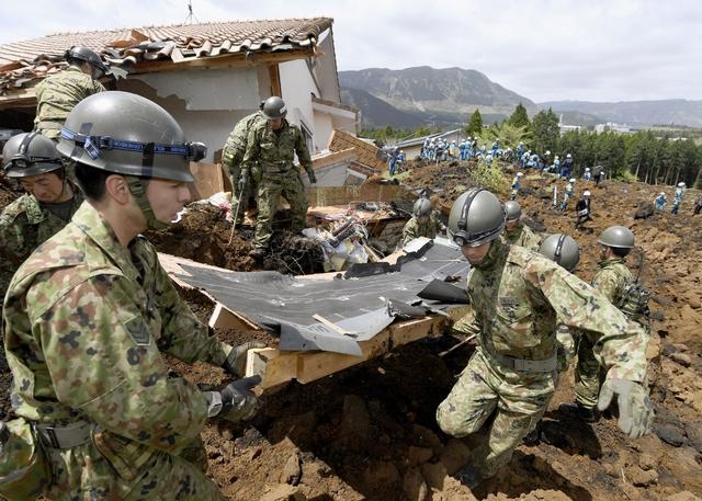 Japan Self-Defense Forces members conduct a search operation at the site of a landslide caused by an earthquake in Minamiaso, Kumamoto prefecture, Japan, Sunday, April 17, 2016. Two nights of incr ...