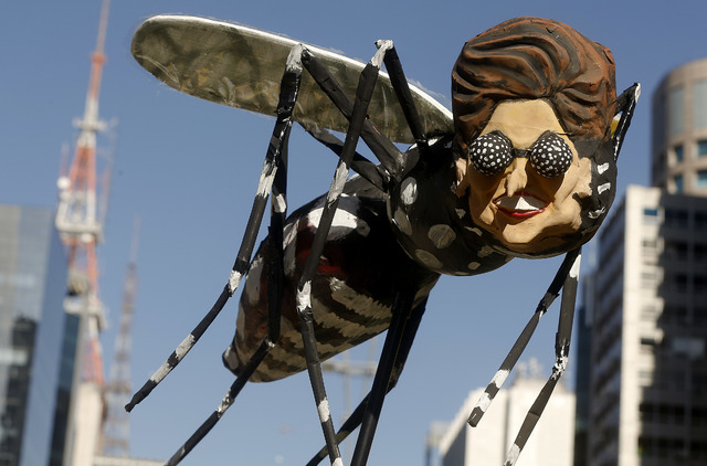 A demonstrator holds a Aedes aegypti mosquito doll depicting Brazil's President Dilma Rousseff during protest demanding her impeachment in Sao Paulo, Brazil, Sunday, April 17, 2016. Today's vote i ...