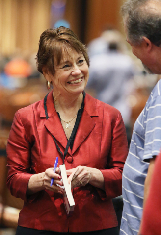 United States Senate candidate Sharron Angle meets with a supporter during a book signing and campaigning stop at the Clark County Republican Party county convention at the Rio hotel-casino Saturd ...