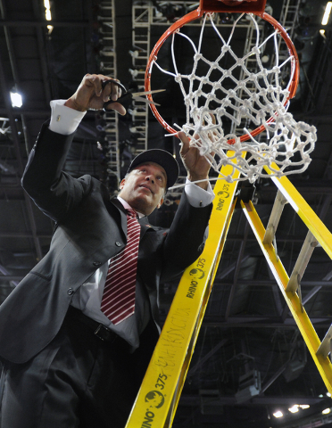 New Mexico State coach Marvin Menzies cuts down the net after his team's victory over UT Arlington in their Western Athletic Conference tournament championship NCAA college basketball game, Saturd ...