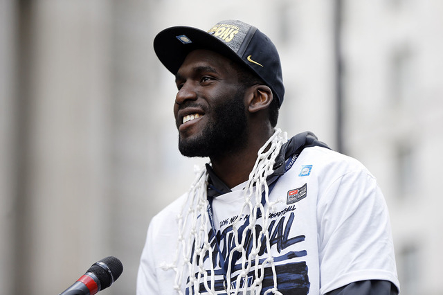 Villanova's Daniel Ochefu speaks as he and his basketball teammates take part in a rally celebrating the team's NCAA college basketball championship, Friday, April 8, 2016, in Philadelphia. (AP Ph ...