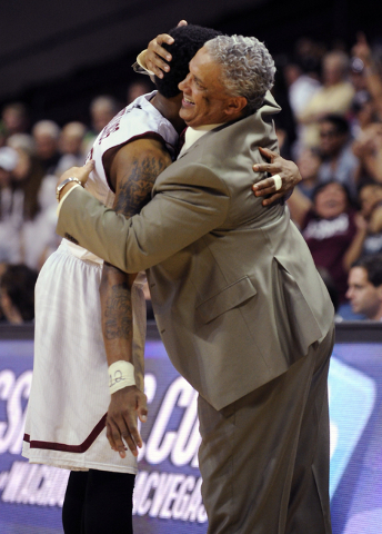 New Mexico State's Daniel Mullings, left, is hugged by coach Marvin Menzies after their team defeated Idaho 77-55 for the championship of the Western Athletic Conference tournament, in an NCAA col ...