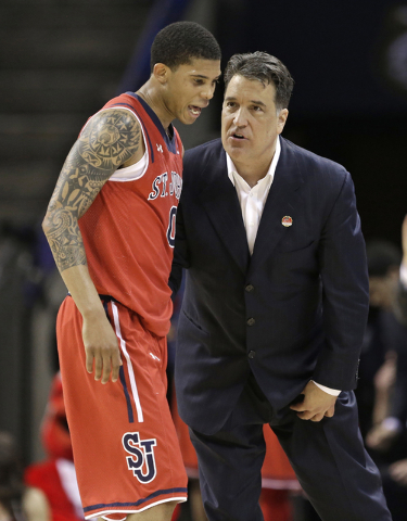St. John's head coach Steve Lavin, right, talks with Jamal Branch (0) during the second half of an NCAA tournament college basketball game against San Diego State in the Round of 64 in Charlotte,  ...