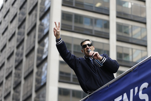 Villanova head coach Jay Wright gestures as the team takes part in a parade celebrating their NCAA college men's basketball championship, Friday, April 8, 2016, in Philadelphia. (AP Photo/Matt Ro ...