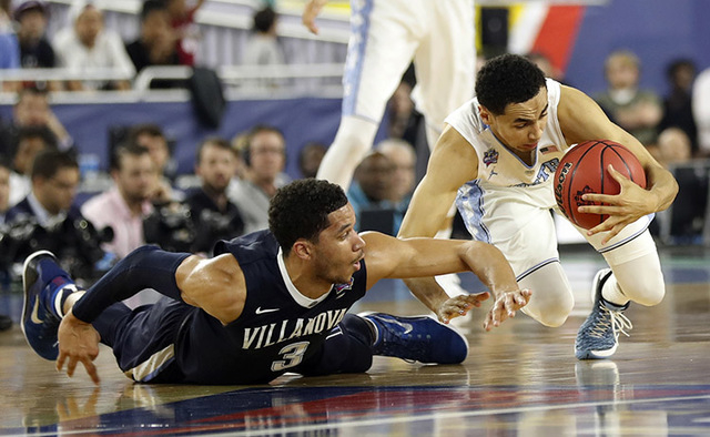 North Carolina's Marcus Paige battles for a loose ball against Villanova's Josh Hart (3) during the second half of the NCAA Final Four tournament college basketball championship game Monday, April ...