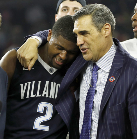 Villanova head coach Jay Wright, right, embraces Kris Jenkins after Jenkins scored a game winning three point basket in the closing seconds of the NCAA Final Four tournament college basketball cha ...