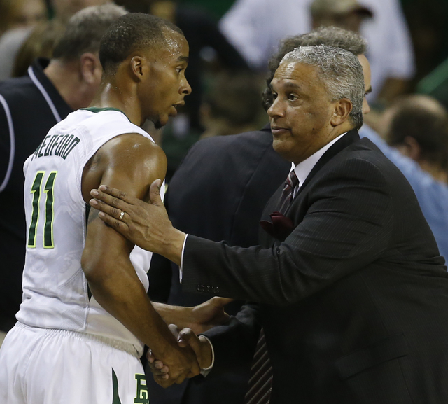 New Mexico State head basketball coach Marvin Menzies, right, shakes hands with Baylor guard Lester Medford (11), left, following of an NCAA college basketball game, Wednesday, Dec. 23, 2015, in W ...