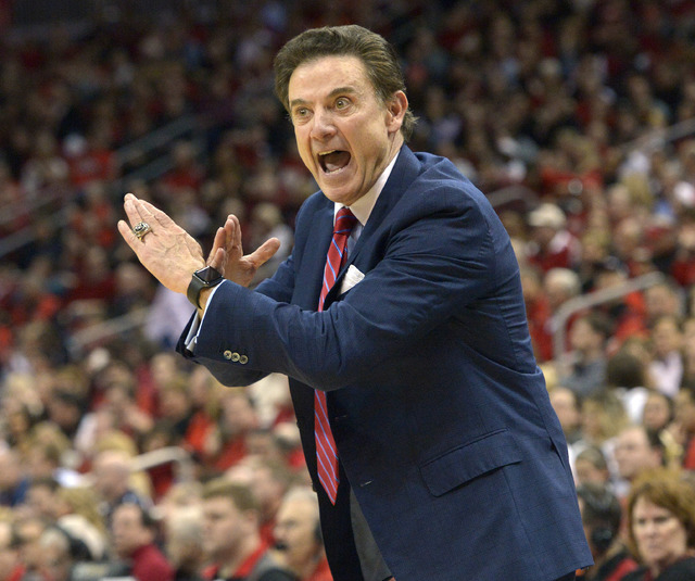 Louisville head coach Rick Pitino sends a play in to his team during the first half of an NCAA college basketball game against Syracuse, Wednesday, Feb. 17, 2016, in Louisville Ky. Louisville won  ...