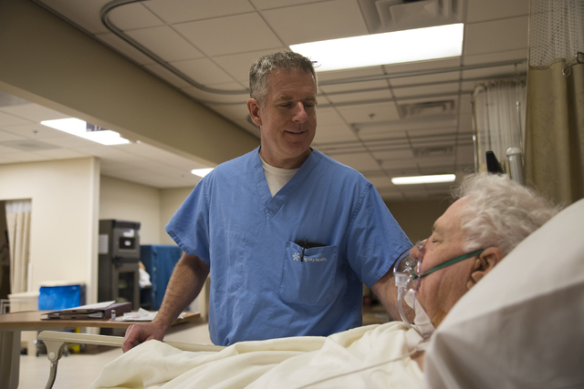 Don Fox, right, recovers from his surgery as his surgeon, Dr. Frederick Goll, stands at his bedside at St. Rose Dominican Hospital's Siena Campus in Henderson on Friday, April 8, 2016. (Daniel Cla ...