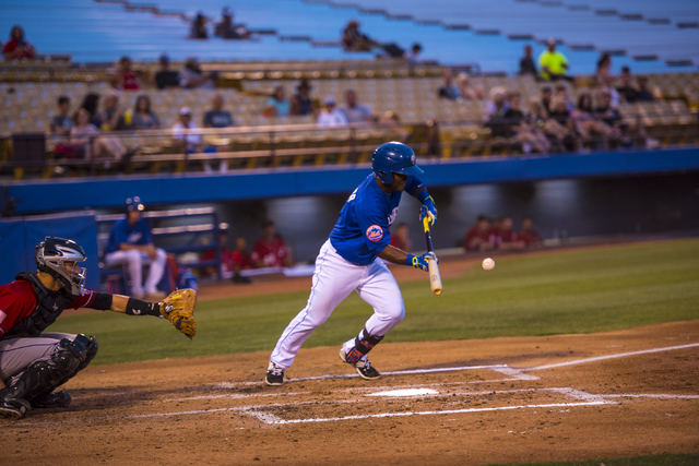 Dilson Herrera, 2, of the Las Vegas 51's, bunts during baseball action against the Albuquerque Isotopes at Cashman Field in Las Vegas on Sunday, July 5, 2015. (Joshua Dahl/Las Vegas Review-Journal)