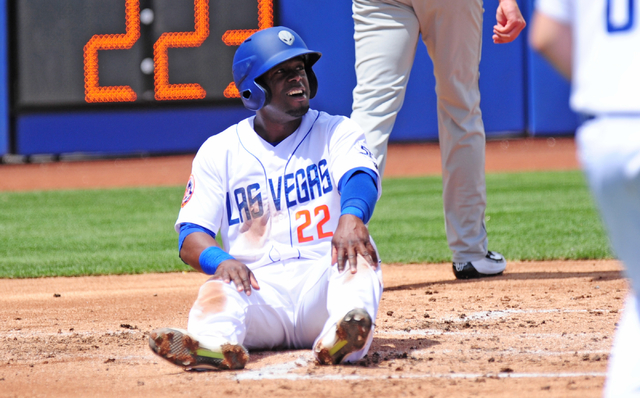 Las Vegas 51s base runner Roger Bernadina reacts after being tagged out at home plate by Albuquerque catcher Nick Hundley in the first inning of their Triple-A minor league baseball game. (Josh Ho ...