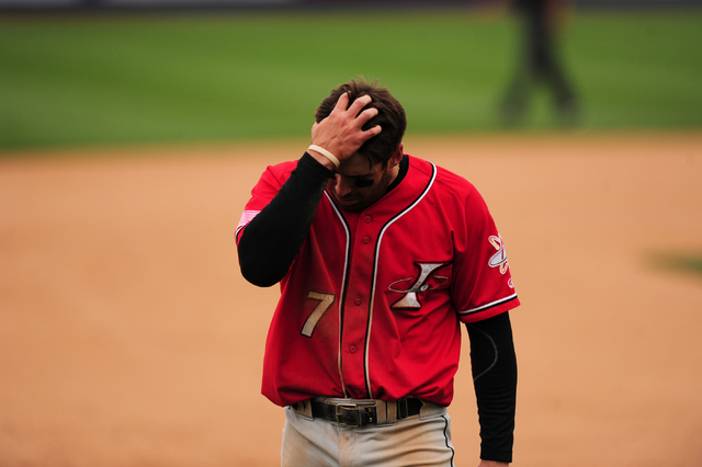 Albuquerque Isotopes base runner Stephen Cardullo reacts after getting caught in a Las Vegas 51s double play in the seventh inning of their Triple-A minor league baseball game at Cashman Field in  ...