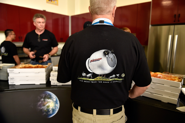 An employee selects his slice of pizza during a party celebrating the launch of the Bigelow Expandable Activity Module aboard a SpaceX rocket at Bigelow Aerospace Friday, April 8, 2016, in North L ...