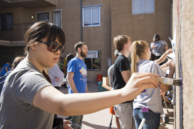 Michelle Jia works to paint a mural during a volunteer event held by the Gaels Give Hope organization from Bishop Gorman High School, benefitting a New Genesis Transitional Housing apartment compl ...