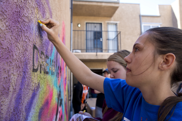 Olivia McEvoy works on mural during a volunteer event held by the Gaels Give Hope organization from Bishop Gorman High School, benefitting a New Genesis Transitional Housing apartment complex in L ...