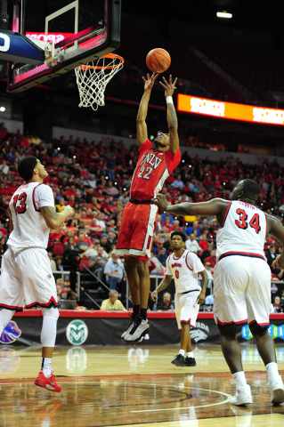 UNLV guard Patrick McCaw (22) goes up for a shot against Fresno State center Terrell Carter II (34) and forward Cullen Russo in the second half of their Mountain West Conference semifinal basketba ...