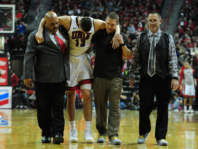 UNLV forward Ben Carter (13) is carried off the floor in the first half of an NCAA college basketball game against San Diego State at the Thomas & Mack Center in Las Vegas Saturday, Jan. 30, 2 ...