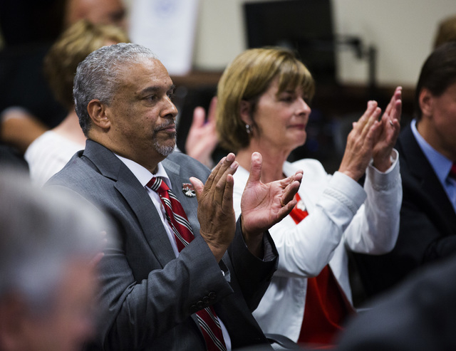 New UNLV men's basketball coach Marvin Menzies,left, and Tina Murphy-Kunzel applaud after the University of Nevada Board of Regents approved his contract on Friday, April 22, 2016. (Jeff Scheid/La ...