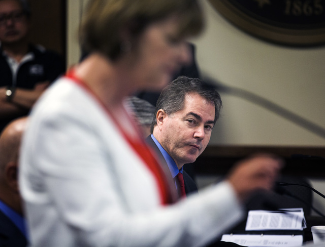 UNLV president Len Jessup, right, listens while Tina Murphy-Kunzel addresses University of Nevada Board of Regents, Friday, April 22, 2016, to approve the contract for new UNLV men's basketball co ...
