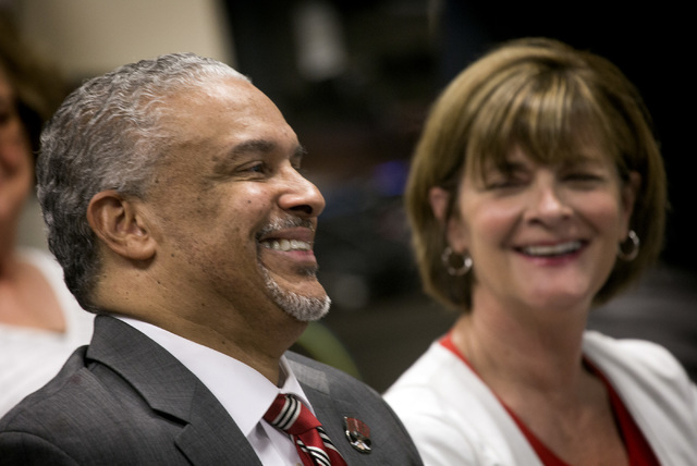New UNLV men's basketball coach Marvin Menzies,left, and Tina Murphy-Kunzel smile after the University of Nevada Board of Regents approved his contract on Friday, April 22, 2016. Jeff Scheid/Las V ...