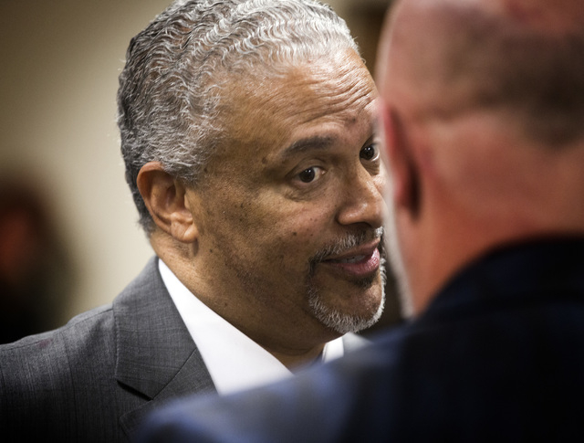 New UNLV men's basketball coach Marvin Menzies, left, talks to regent James Dean Levitt during the University of Nevada Board of Regents meeting to approve his contract on Friday, April 22, 2016. ...