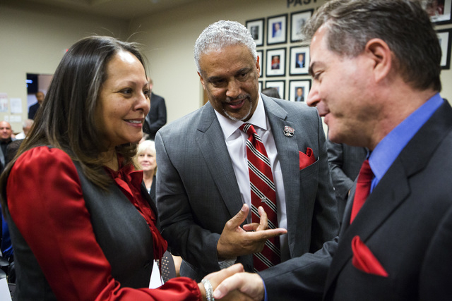 New UNLV men's basketball coach Marvin Menzies, center, introduces his wife Tammy to UNLV president Len Jessup before the University of Nevada Board of Regents approved his contract on Friday, Apr ...