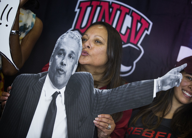 Tammy Menzies kisses a cardboard cutout of her husband and new UNLV men's basketball coach Marvin Menzies during a press conference at Mendenhall Center on Friday, April 22, 2016. Jeff Scheid/Las  ...