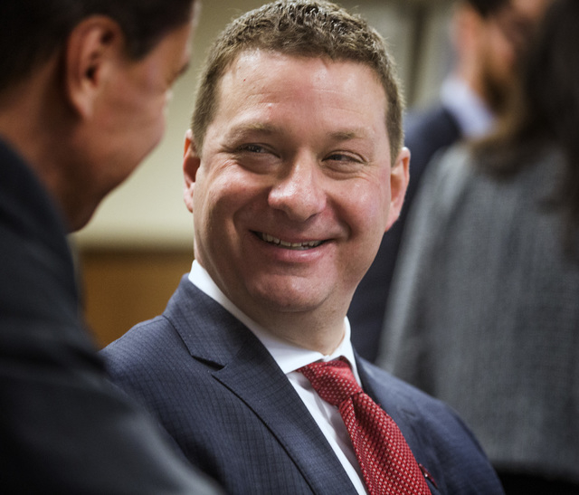 New UNLV basketball coach Chris Beard, right, talks to Darryl Seibel, UNLV deputy director of athletics for external affairs, during the University of Nevada Board of Regents hearing on Friday, Ap ...