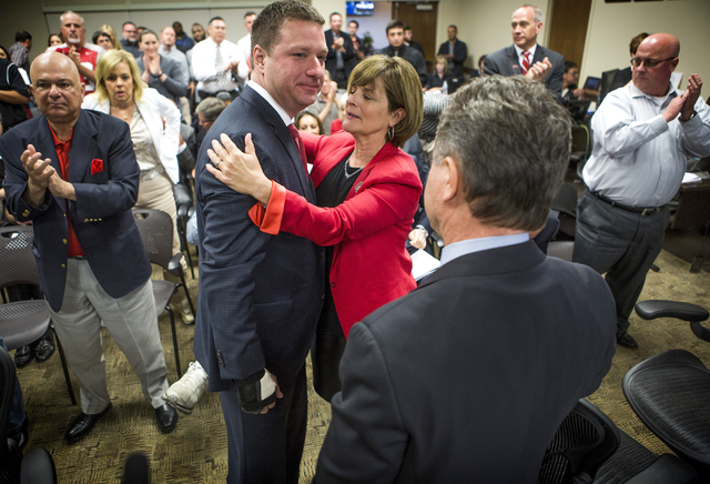 UNLV Director of Athletics Tina Kunzer-Murphy, center, hugs new UNLV basketball coach Chris Beard after  University of Nevada Board of Regents approved his contract Friday, April 8, 2016. On the r ...