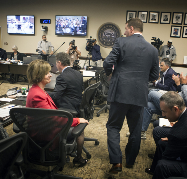 A relieved UNLV Director of Athletics Tina Kunzer-Murphy, left, sits while new UNLV basketball coach Chris Beard walks past her after University of Nevada Board of Regents approved his contract Fr ...