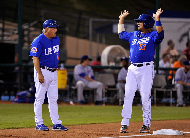 Las Vegas coach Wally Backman, left, speaks with base runner Bobby Abreu at third base during a baseball game against the Round Rock Express at Cashman Field on Tuesday, Aug. 26, 2014. The 51s hav ...