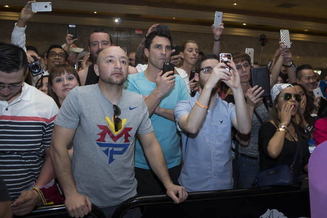 Fans take photos of Manny Pacquiao at the MGM Grand Garden Arena in advance of his boxing fight this weekend on Tuesday, April 5, 2016, in Las Vegas. Pacquiao will fight Timothy Bradley for a thir ...