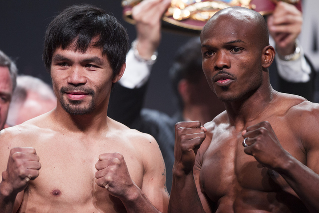 Manny Pacquiao, left, and Timothy Bradley pose during a weigh-in at the MGM Grand Garden Arena on Friday, April 8, 2016, in Las Vegas. Pacquiao and Bradley will fight for a third time tomorrow nig ...