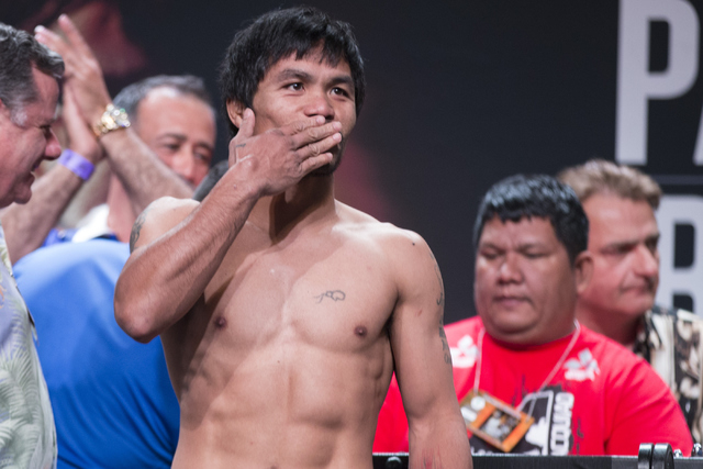 Manny Pacquiao poses on stage during a weigh-in at the MGM Grand Garden Arena on Friday, April 8, 2016, in Las Vegas. Pacquiao will fight for a third time against Timothy Bradley tomorrow night. E ...