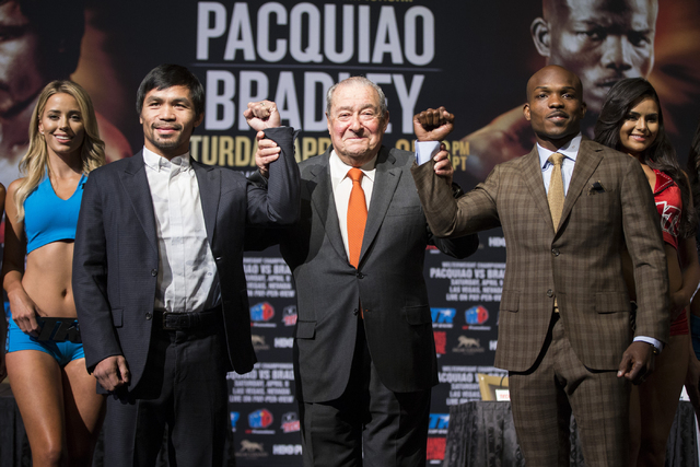 Boxing promoter Bob Arum, center, poses with Manny Pacquiao, left, and Timothy Bradley, during the final press conference before their boxing fight at the MGM Grand casino-hotel on Wednesday, Apri ...