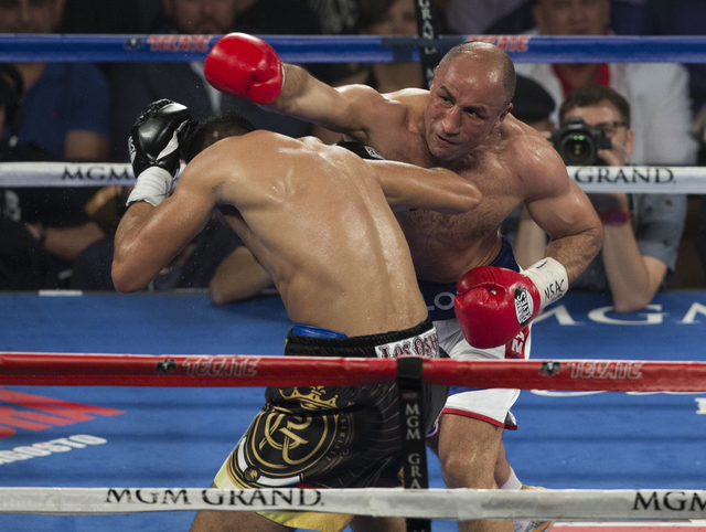Arthur Abraham connects on punch against Gilberto Ramirez during the international WBO super middleweight championship at the MGM Grand Garden Arena, Saturday, April 9, 2016, in Las Vegas. Benjami ...