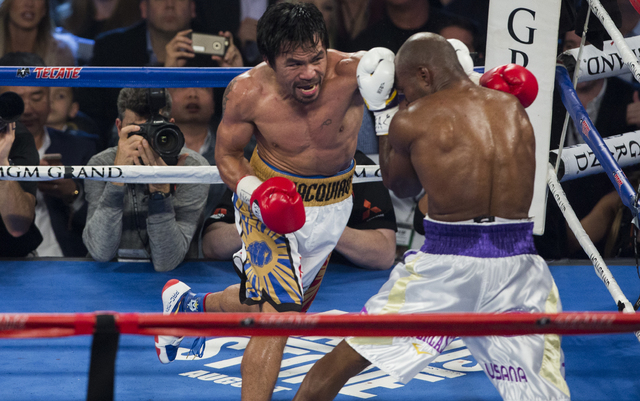 Manny Pacquiao connects on punch against Timothy Bradley during the international WBO welterweight championship at the MGM Grand Garden Arena, Saturday, April 9, 2016, in Las Vegas. (Benjamin Hage ...