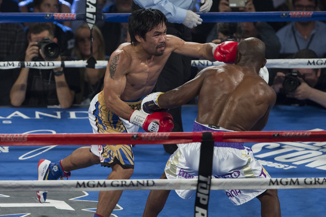 Manny Pacquiao connects on punch against Timothy Bradley during the international WBO welterweight championship at the MGM Grand Garden Arena, Saturday, April 9, 2016, in Las Vegas. (Benjamin Hage ...