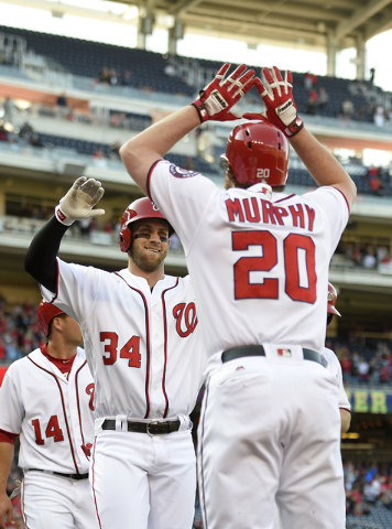 Washington Nationals' Bryce Harper (34) celebrates his grand slam with Daniel Murphy during the third inning of an baseball game against the Atlanta Braves, Thursday, April 14, 2016, in Washington ...