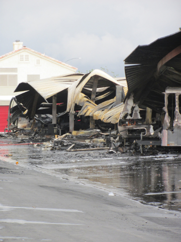 Ash and debris remain under a warped metal awning following a fire that caused an estimated $2.5 million in damage at the Storage at Summerlin business on West Lake Mead Boulevard on Saturday, Apr ...