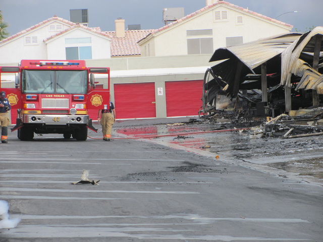 Firefighters work at the scene of a fire at the Storage at Summerlin business on West Lake Mead Boulevard on Saturday, April 9, 2016. The fire damaged or destroyed 37 boats, RVs, travel trailers a ...