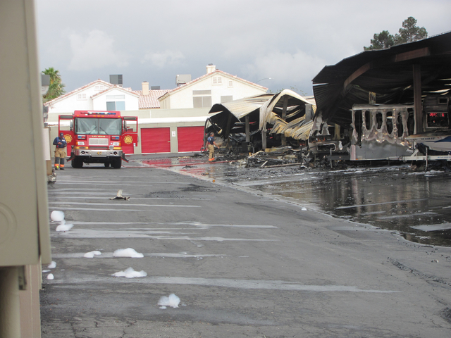 Firefighters work at the scene of a fire at the Storage at Summerlin business on West Lake Mead Boulevard on Saturday, April 9, 2016. The fire damaged or destroyed 37 boats, RVs, travel trailers a ...