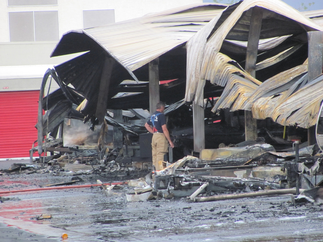 An investigator works at the scene of a fire at the Storage at Summerlin business on West Lake Mead Boulevard on Saturday, April 9, 2016. The fire damaged or destroyed 37 boats, RVs, travel traile ...