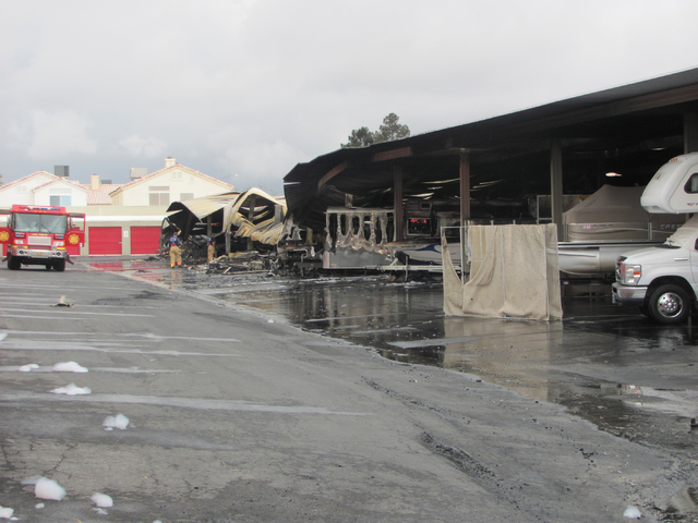 An investigator works at the scene of a fire at the Storage at Summerlin business on West Lake Mead Boulevard on Saturday, April 9, 2016. The fire damaged or destroyed 37 boats, RVs, travel traile ...