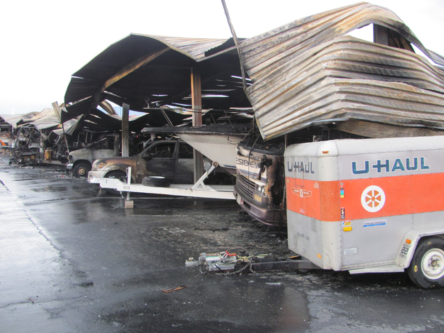 The warped metal awning is shown above burned RVs, boats and travel trailers following a fire at the Storage at Summerlin business on West Lake Mead Boulevard on Saturday, April 9, 2016. The fire  ...