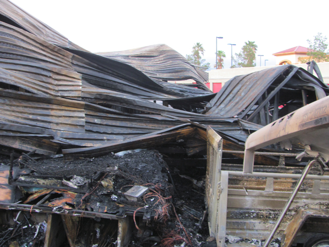 A collapsed metal awning is shown following a fire at the Storage at Summerlin business on West Lake Mead Boulevard on Saturday, April 9, 2016. The fire damaged or destroyed 37 boats, RVs, travel ...