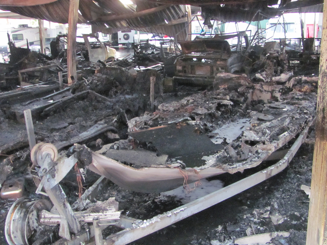 The hull of a boat is barely discernible after a fire at the Storage at Summerlin business on West Lake Mead Boulevard on Saturday, April 9, 2016. The fire damaged or destroyed 37 boats, RVs, trav ...